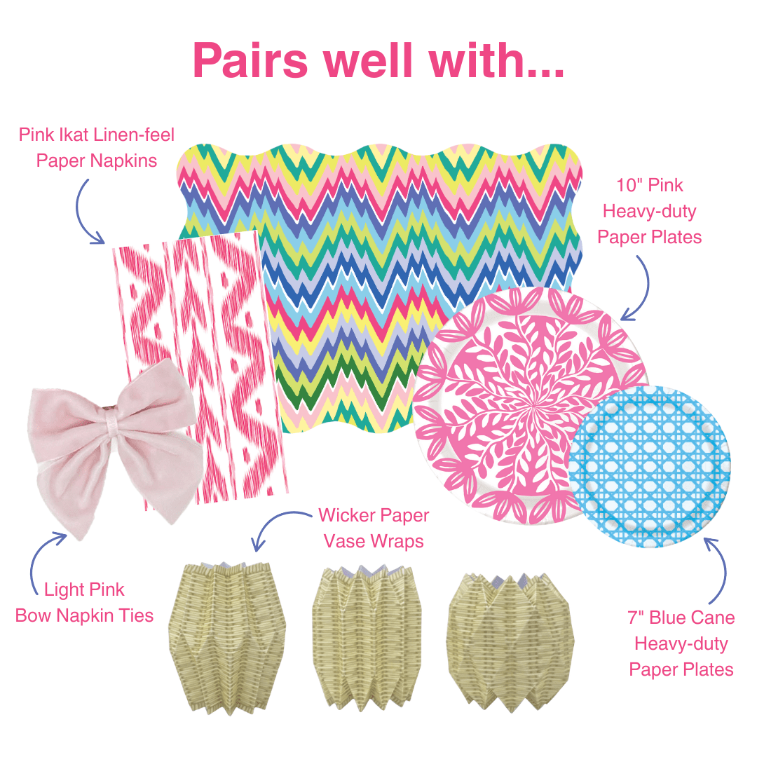 Graphic showing coordinating table decor items including pink ikat-style paper napkins, multicolored zigzag placemat, pink floral and blue patterned paper plates, light pink bow napkin ties, and wicker-style paper vase wraps, labeled as items that pair well together.