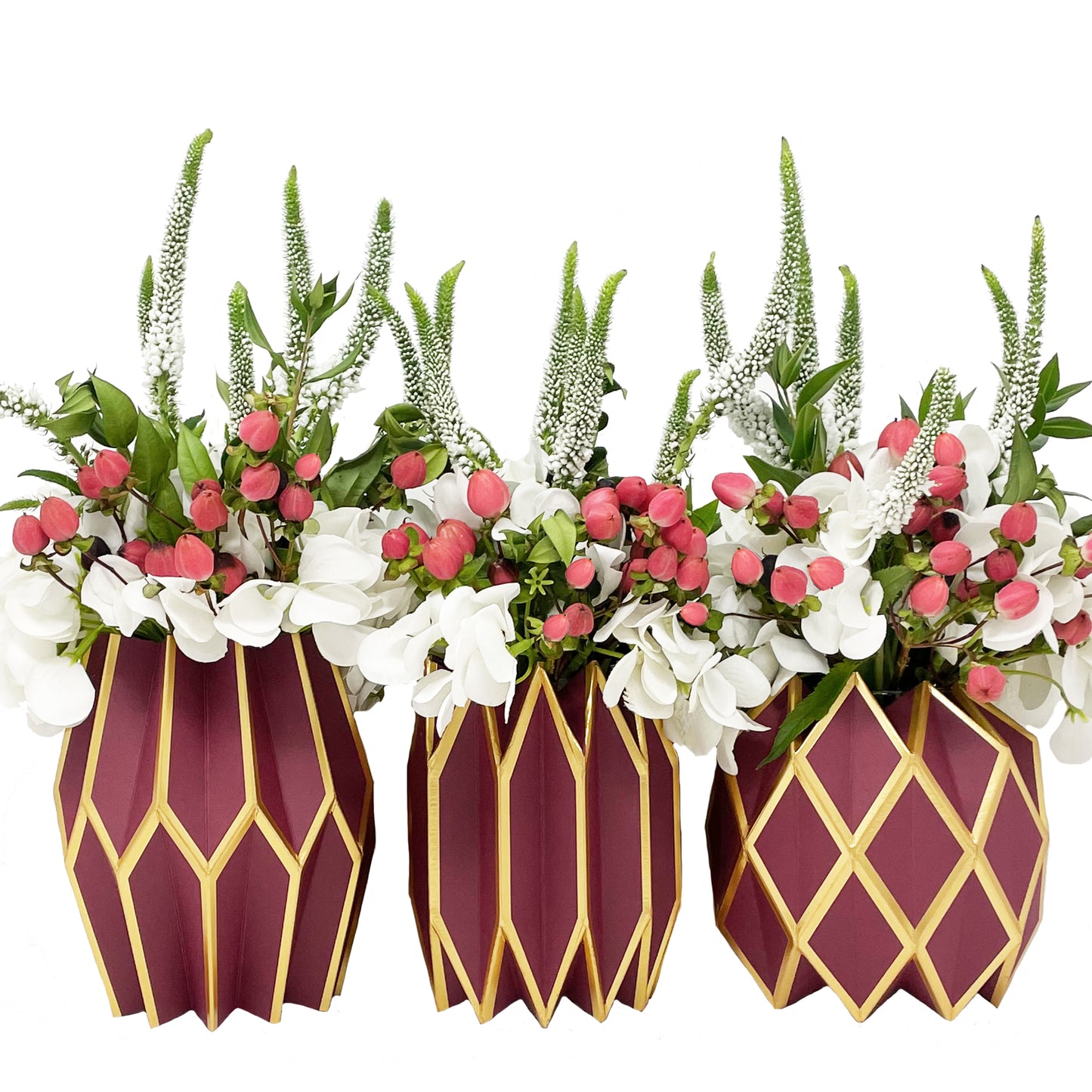 Three flower arrangements featuring our paper vase wraps in deep red color with gold accents