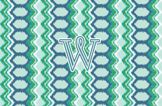Paper placemat featuring a blue and green pattern with a teal personalized initial