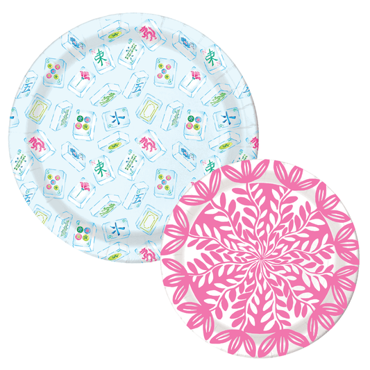 Two paper plates: a light blue mahjong tile-print dinner plate and a pink botanical leaf-print dessert plate