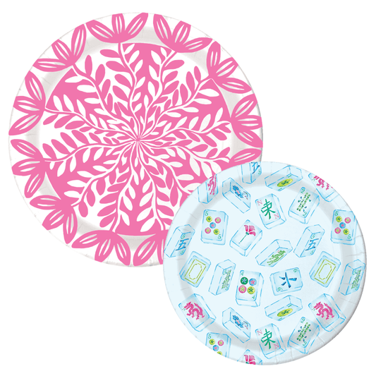 Two paper plates: a pink botanical leaf-print dinner plate and a light blue mahjong tile-print dessert plate