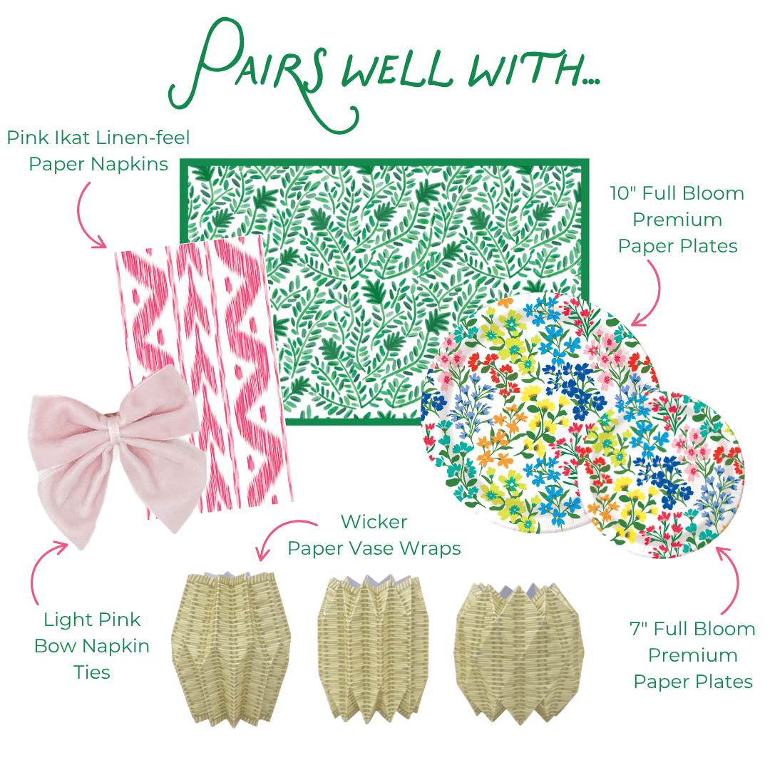 Product assortment with pink ikat linen-feel paper napkins, green floral-patterned paper, colorful floral paper plates, light pink bow napkin ties, wicker paper vase wraps, and pink heavy-duty paper plates.