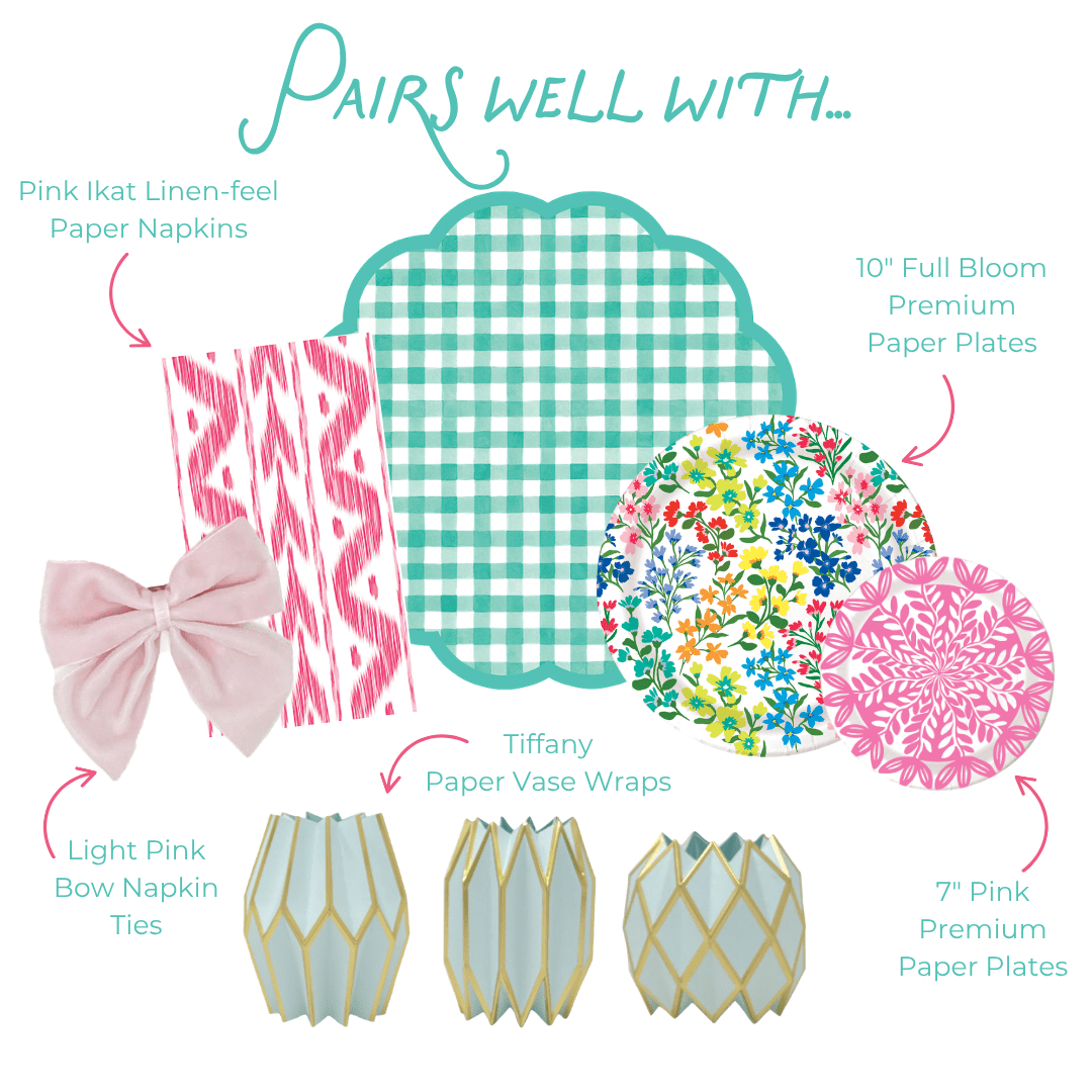 Pairs well with graphic showing six coordinating party products: Pink Ikat Linen-feel Paper Napkins in a pink and white ikat stripe pattern; Light Pink Bow Napkin Ties in soft velvet; Tiffany Paper Vase Wraps in pale blue with gold geometric lattice; a teal green gingham scallop-edged plate; 10-inch Full Bloom Heavy-duty Paper Plates with a colorful wildflower print in pink, blue, yellow, and red; and 7-inch Pink Heavy-duty Paper Plates with a bold pink floral medallion print.