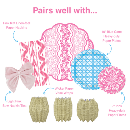 Graphic showing coordinating table decor items including pink ikat-style paper napkins, pink floral scalloped placemat, blue patterned and pink floral paper plates, light pink bow napkin ties, and wicker-style paper vase wraps, labeled as items that pair well together.