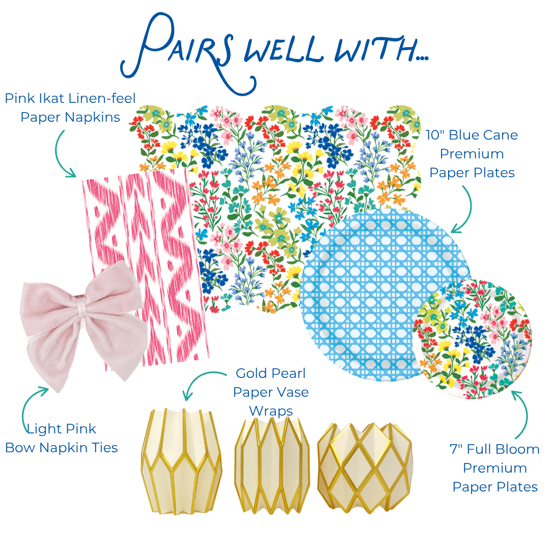 Product assortment: wildflower placemats and plates, blue dinner plates, pink geometric patterned paper napkin, bows, and geometric paper vases