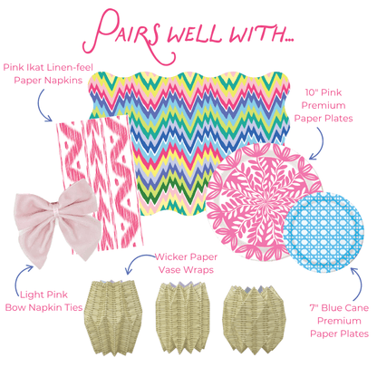 Graphic showing coordinating table decor items including pink ikat-style paper napkins, multicolored zigzag placemat, pink floral and blue patterned paper plates, light pink bow napkin ties, and wicker-style paper vase wraps, labeled as items that pair well together.
