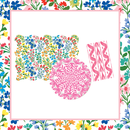 Bundle of multicolor wildflower scalloped placemats, a pink botanical leaf-print paper plate, and pink ikat paper napkins