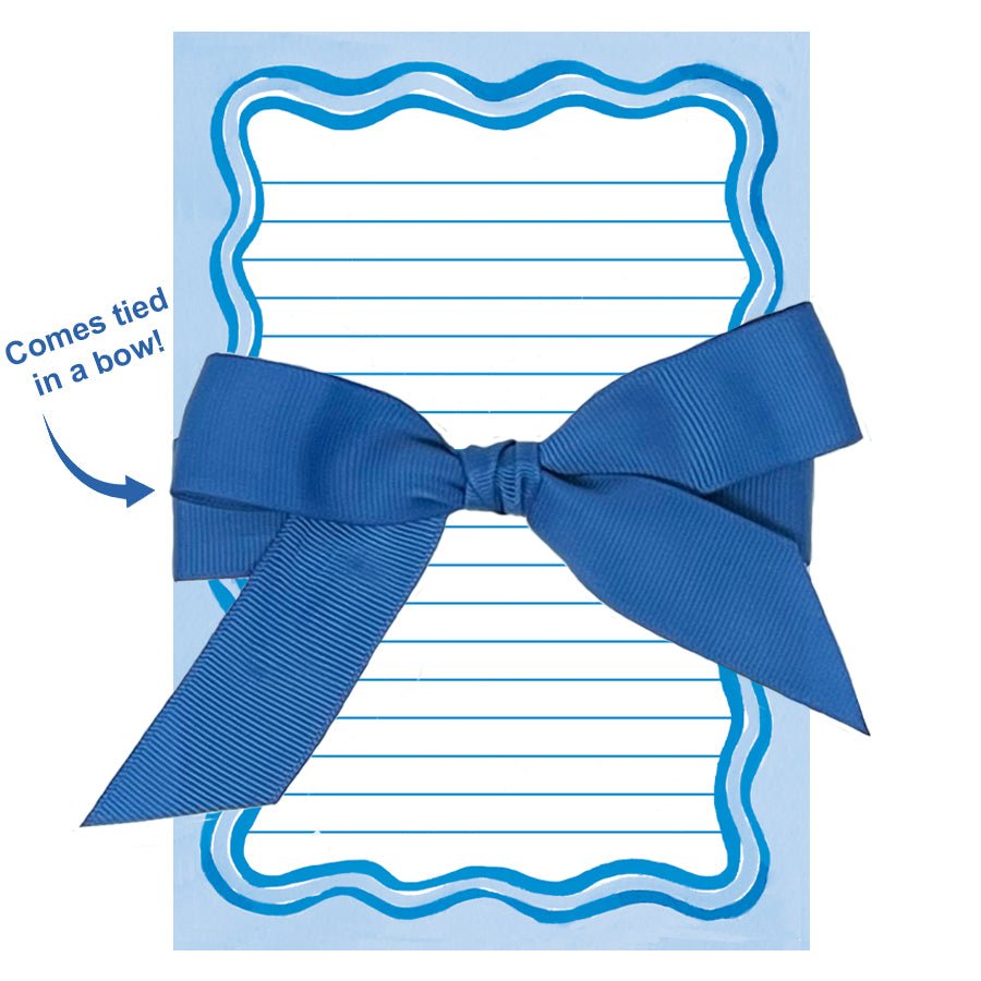 Lined notepad with blue wavy border tied in a bow