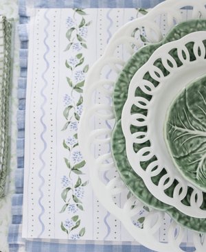 Floral paper placemats with green cabbage dishes
