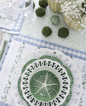 Floral paper placemats with green cabbage dishes