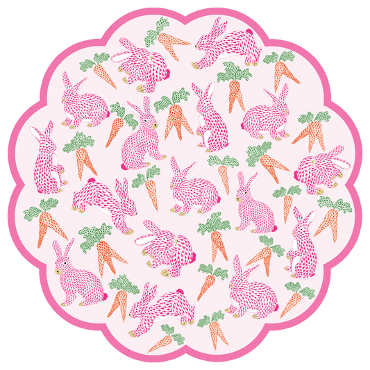 Patterned paper placemat with pink bunnies and carrots on a white background