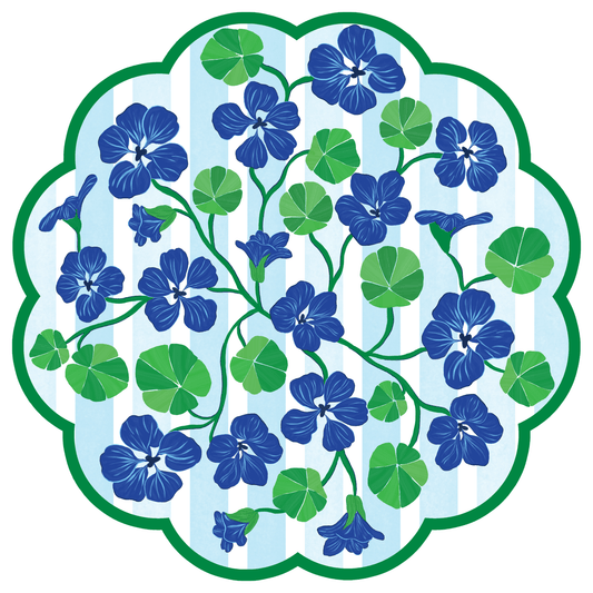 Decorative paper placemat with blue flowers and green leaves on a white background