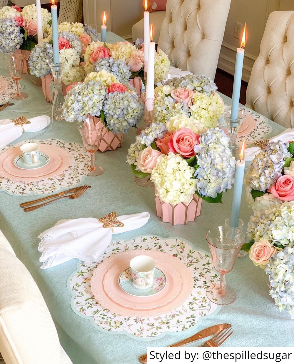 Galentines Day tea party table setting with paper placemats and pastels