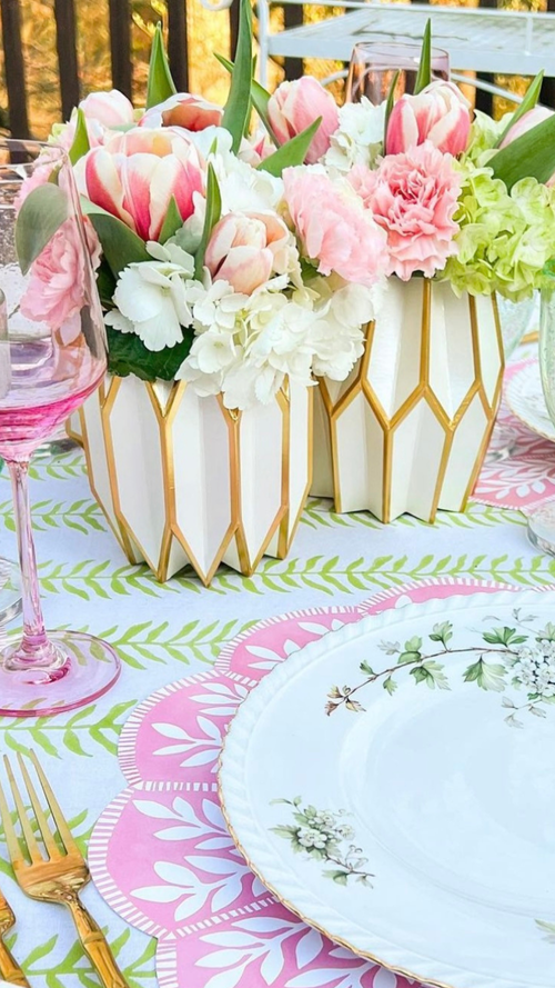 Gold and white centerpieces with spring flowers on a Mother's Day table setting