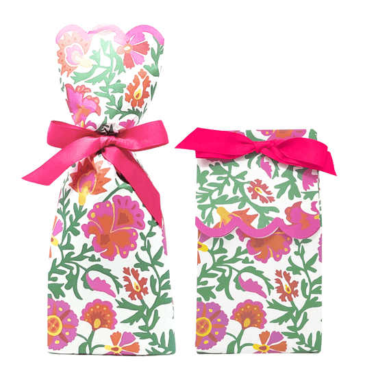 Two paper gift bag kits in a pink, orange, and green bold floral print, shown tied as a tall wine bag and a shorter gift bag, each with a pink ribbon bow