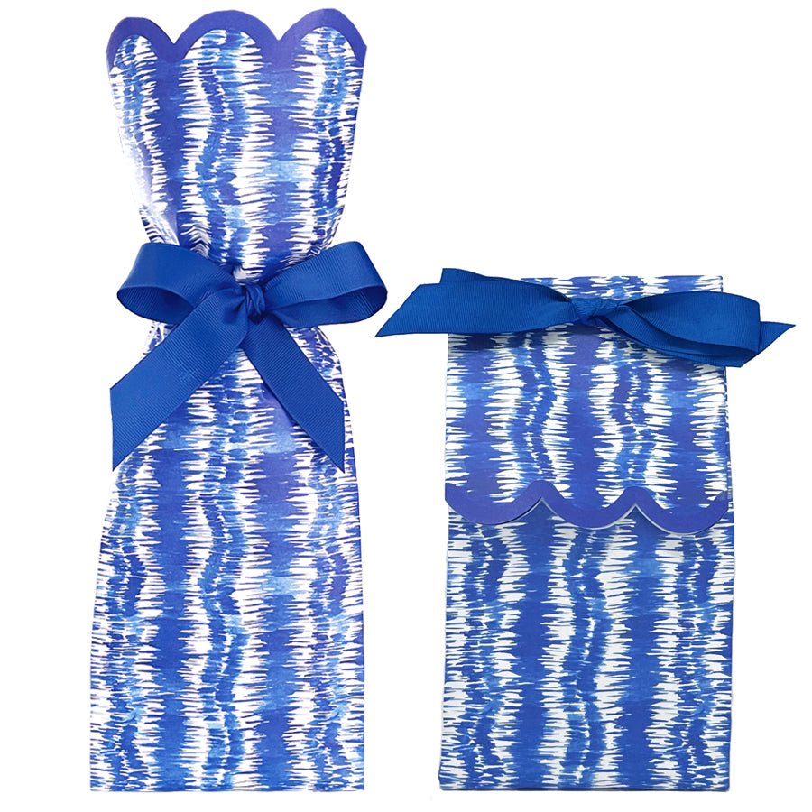Two paper gift bag kits in a blue and white ikat print, shown tied as a tall wine bag and a shorter gift bag, each with a blue ribbon bow