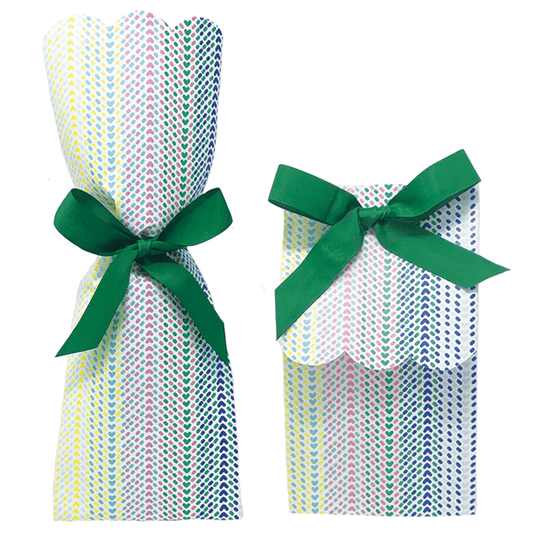 Two paper gift bag kits in a multicolor chevron arrow print, shown tied as a tall wine bag and a shorter gift bag, each with a green ribbon bow