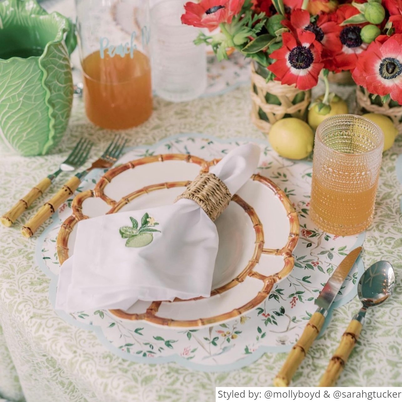 Round scalloped chinoiserie paper placemat layered with a bamboo plate and napkin featuring a lime