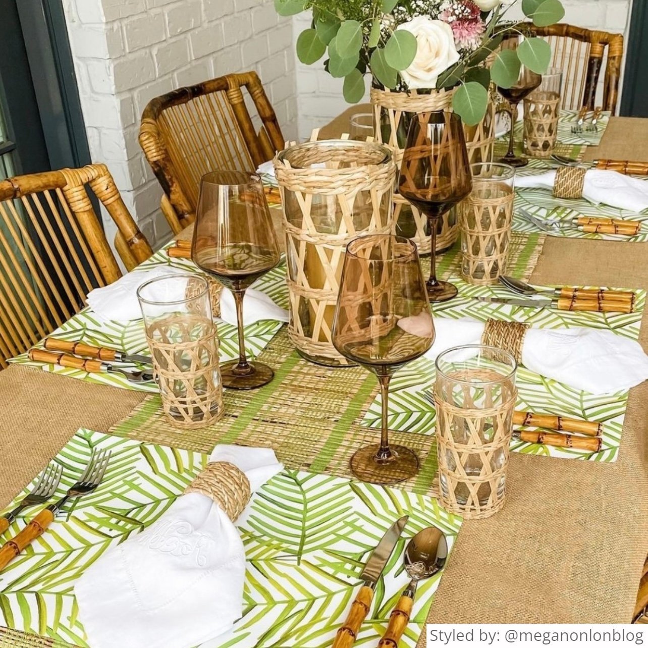 Table set with green palm leaf placemats and bamboo accessories