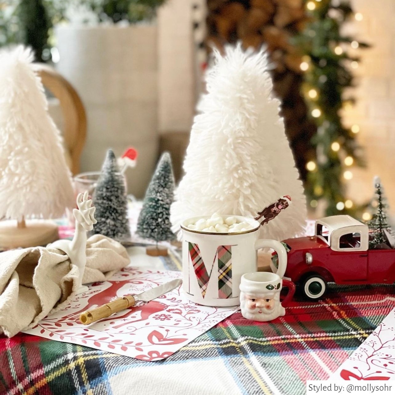 Christmas spread with white and red Reindeer Paper Placemats and red, green and white holiday decor. 