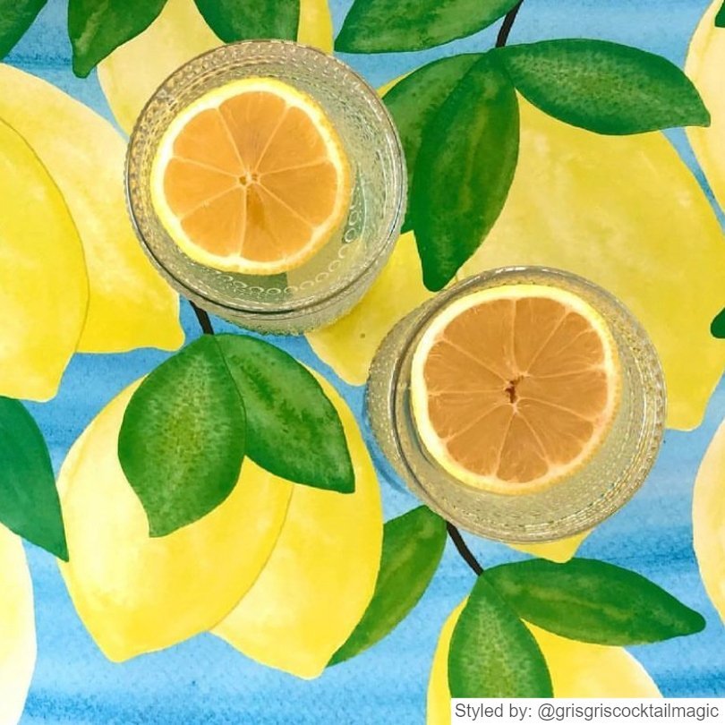 Glasses on lemonade on lemon paper placemat