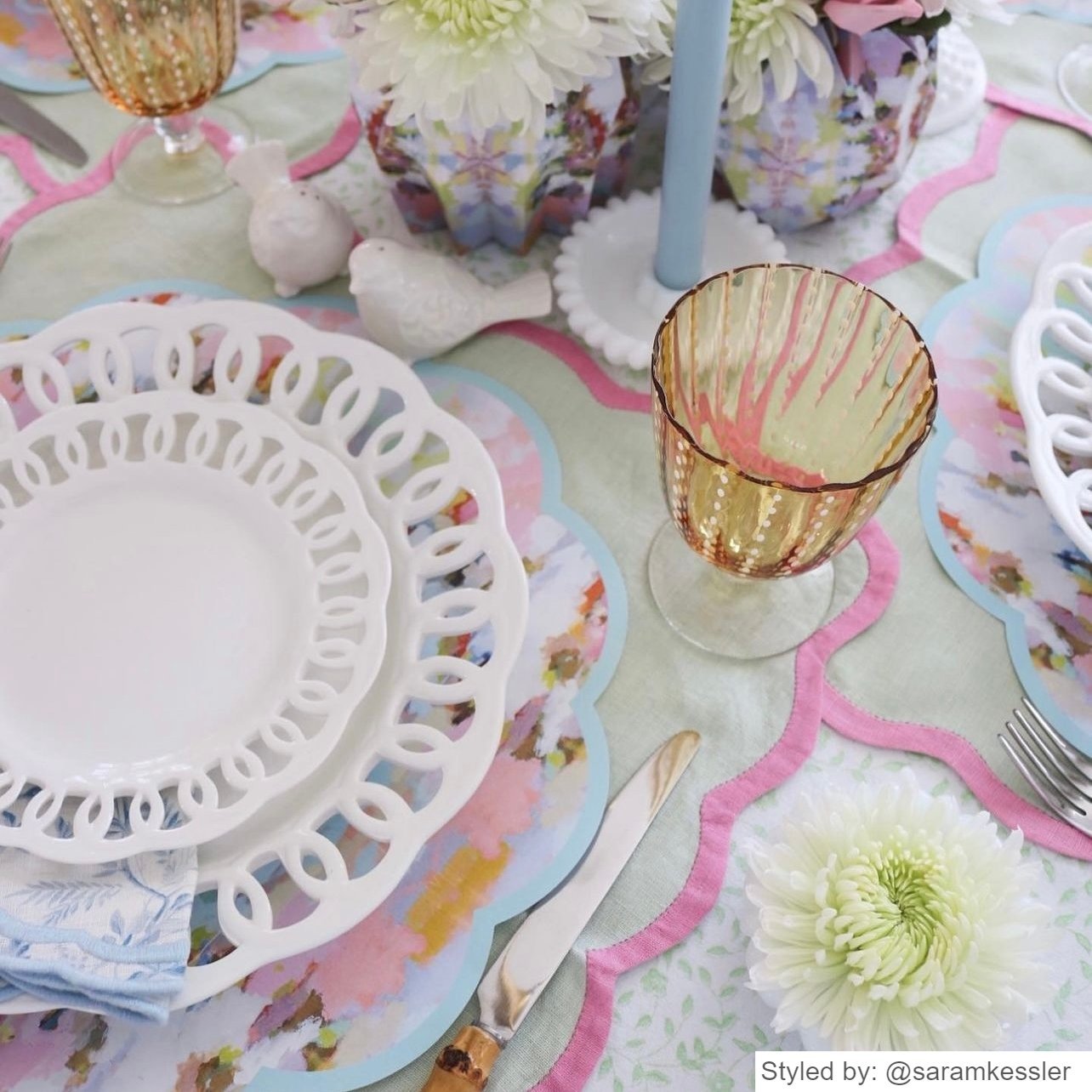 Table set with pink and blue watercolor scalloped paper placemats layered with blue dishes
