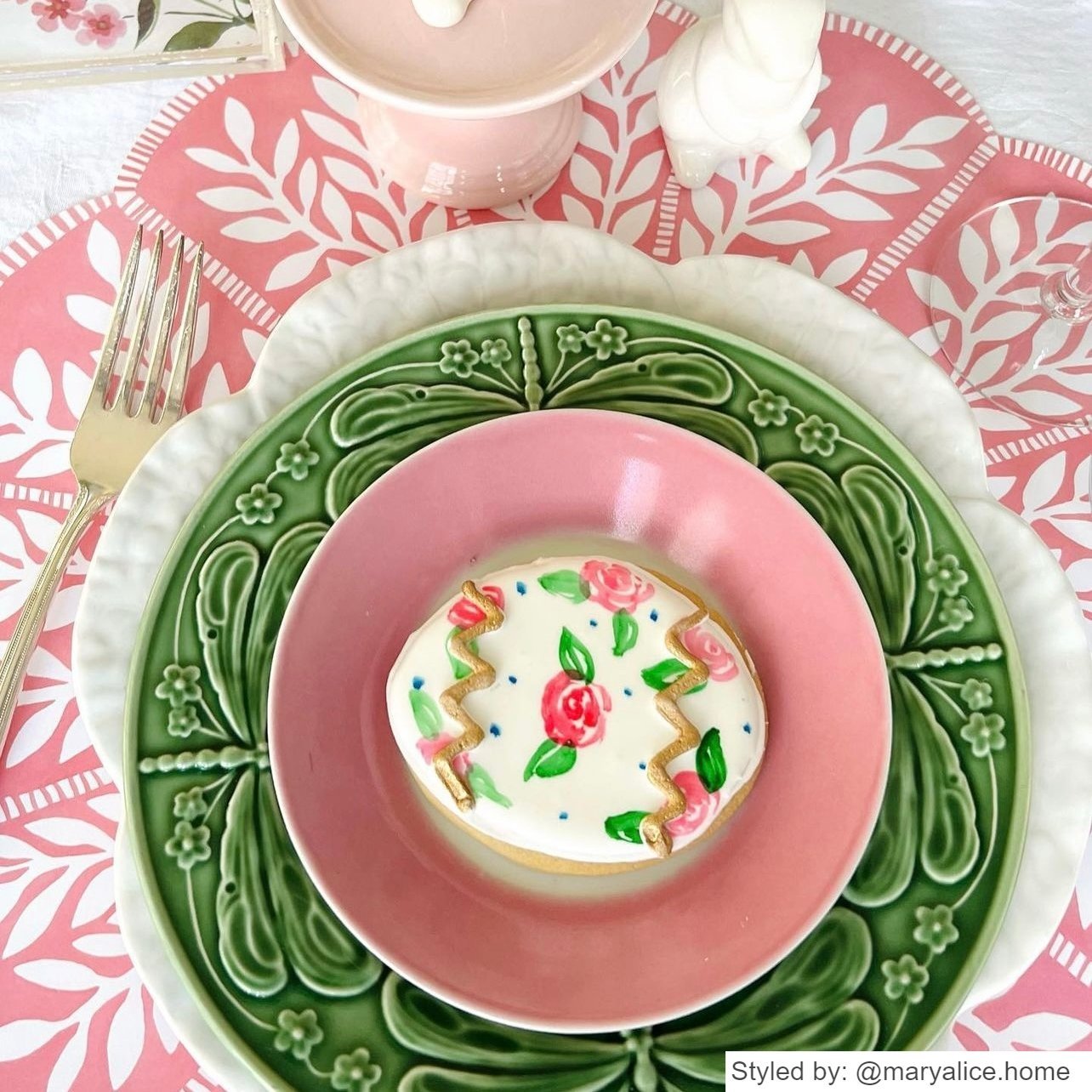 Pink and white scalloped round paper placemat layered with green, white and pink plates