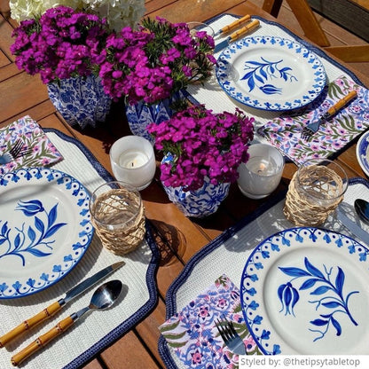 Outdoor blue and white table setting on a wooden table
