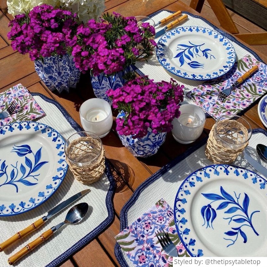 Outdoor blue and white table setting on a wooden table