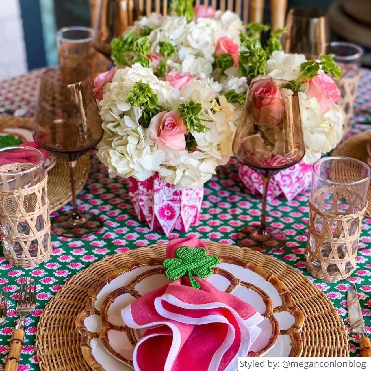 Table setting with a pink chinoiserie paper vase and pink napkin