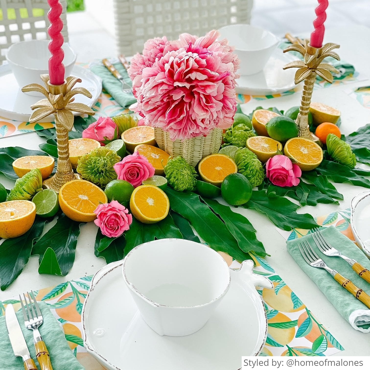 Wicker paper vase wrap with pink flowers on a table setting