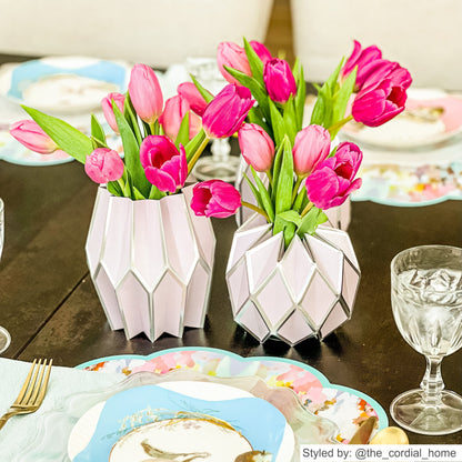 Lavender paper vases with pink tulips on a wooden table
