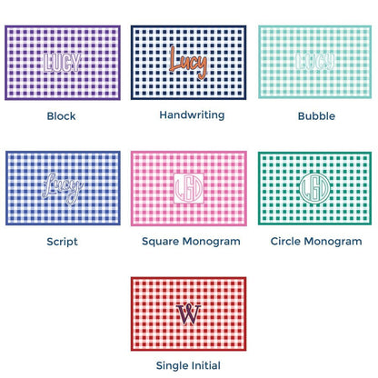 Paper placemat pads featuring a customizable gingham pattern and various personalized name options