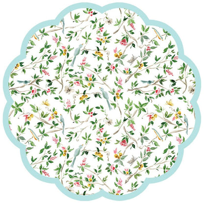 Round scalloped paper placemat featuring a chinoiserie pattern with birds on a cream colored background.