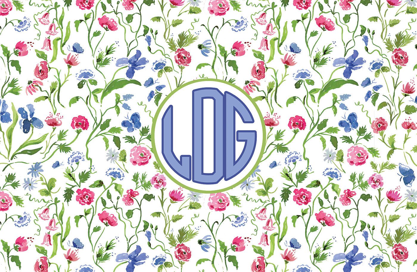 Paper placemat featuring a floral pattern on a cream background with a periwinkle circle monogram