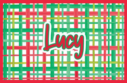 Paper placemat featuring a red and green plaid pattern and red personalized name
