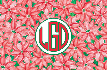 Paper placemat with a red and green poinsettia pattern and a red and green circle monogram