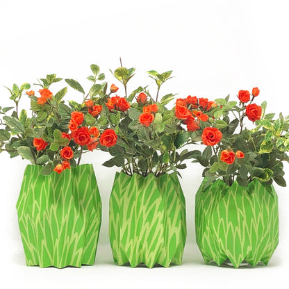 Bright green paper vase sleeve centerpieces with orange flowers
