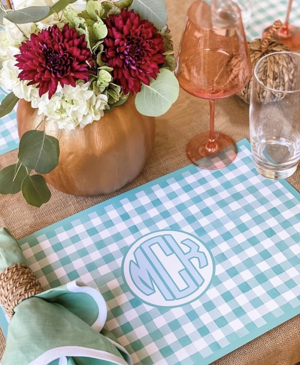 Paper placemat pads featuring a green gingham pattern and various personalization options