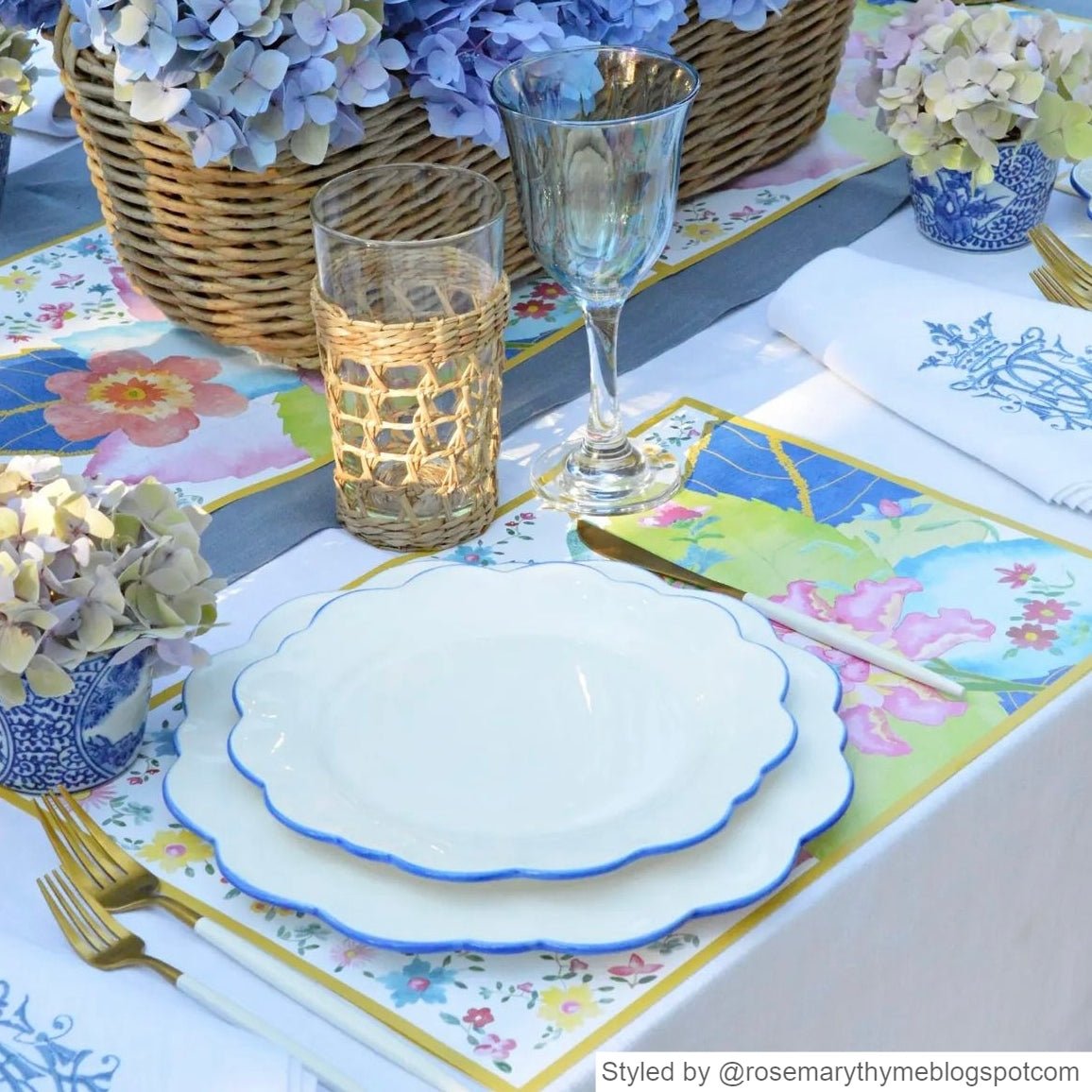 Outdoor blue and white table with Tobacco Leaf patterned paper placemats