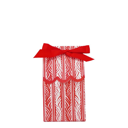 Paper wine bag featuring a red and white vine pattern tied as a gift bag with a red bow