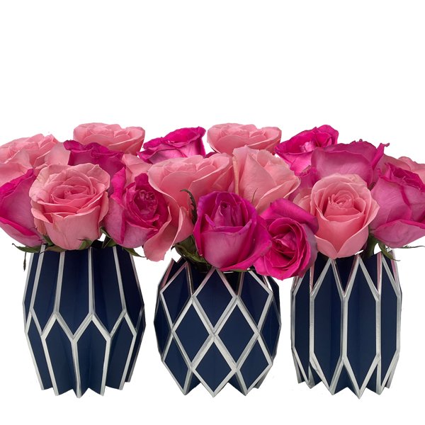 Pink rose floral arrangement featuring our navy blue and silver paper vase wraps