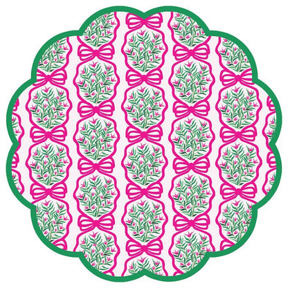 Round scalloped paper placemats featuring a pink and green wreath pattern on a light pink background with green border