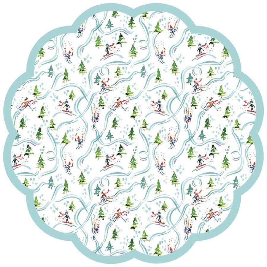 Round scalloped paper placemat featuring a skiier pattern on a white background with a teal border