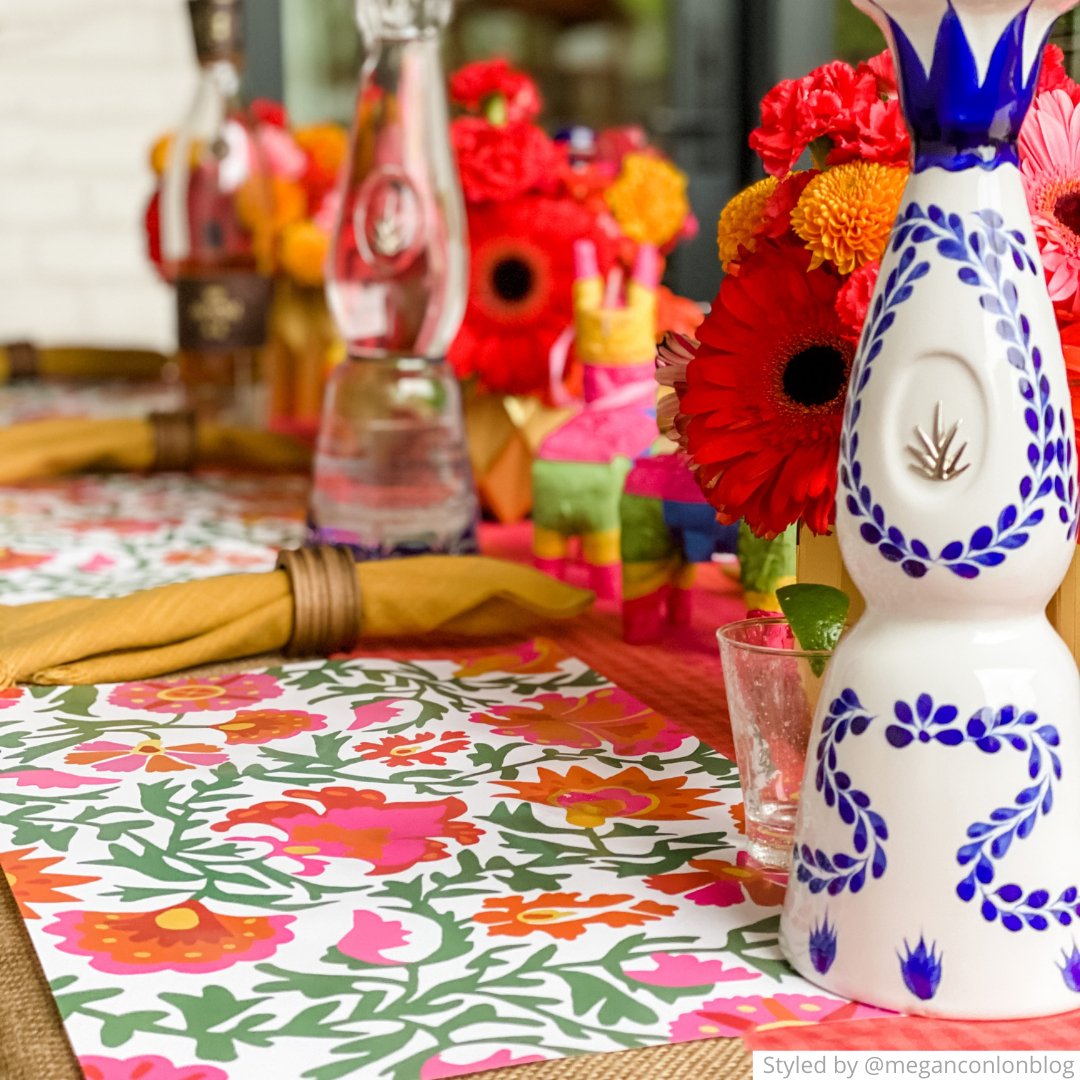 Place setting with pink, green and orange paper placemats and bright centerpieces