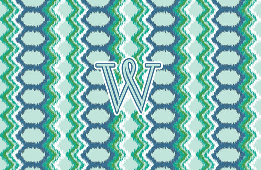 Paper placemat featuring a blue and green pattern with a teal personalized initial